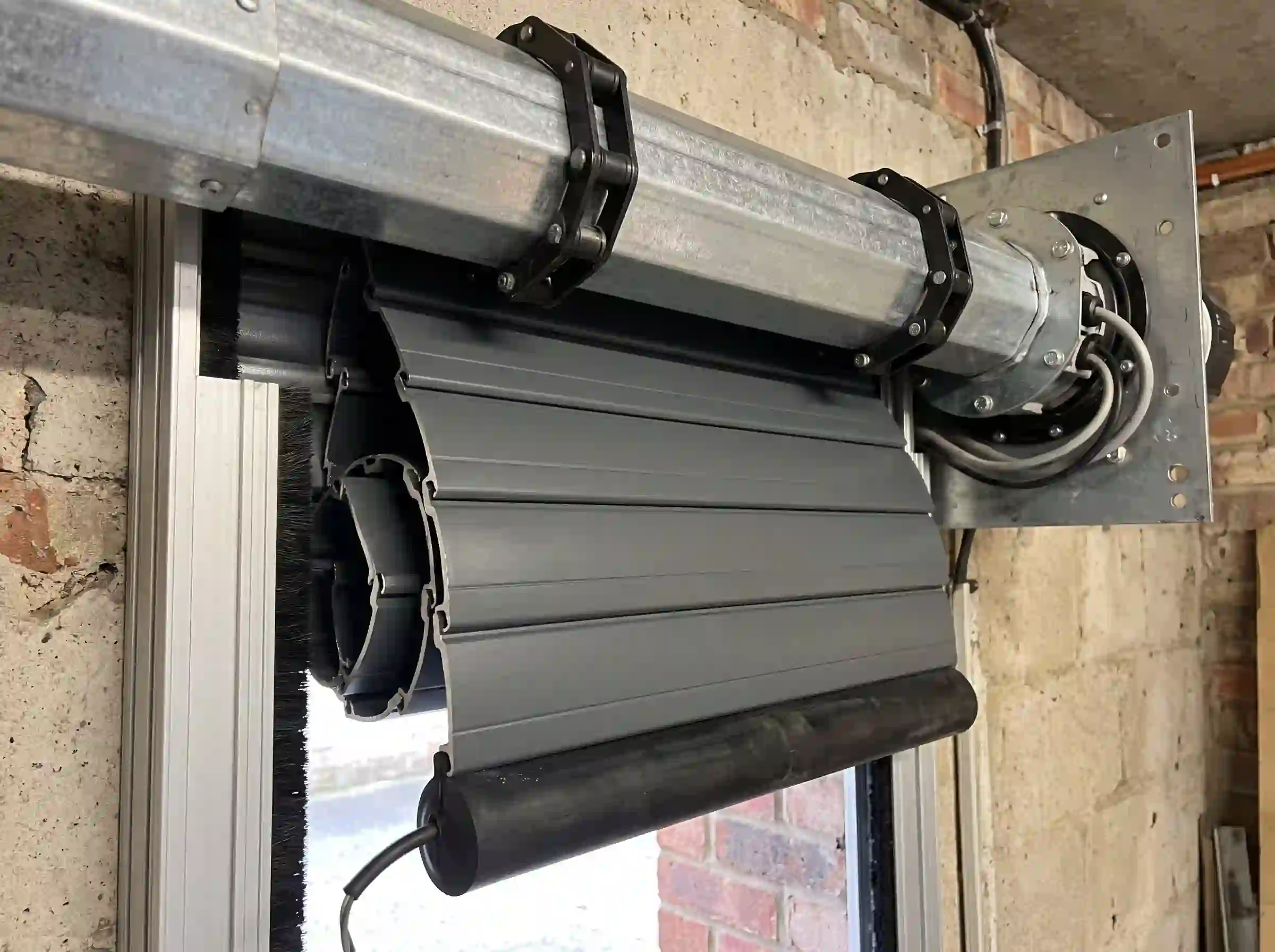 Electric roller shutter garage door tubular motor, interlocking insulated aluminium slats and wireless safety receiver